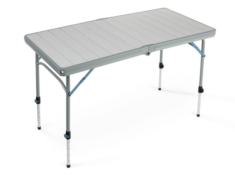 Side view of TrailChef Foldable Camp Table set up beside a tent in rocky terrain