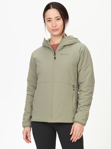 Eco-friendly women's insulated hoody worn on a winter hike, showcasing its warmth and flexibility.