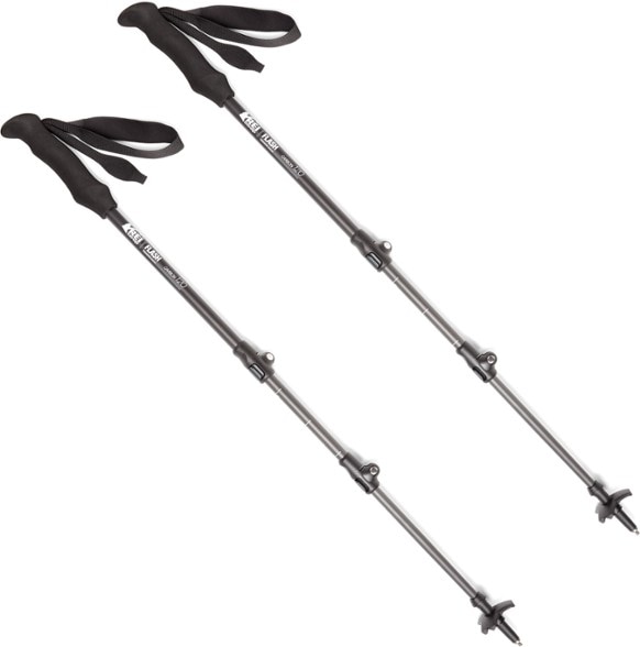 Close-up view of REI Co-op Flash Carbon trekking poles showcasing ergonomic foam grips and adjustable levers.