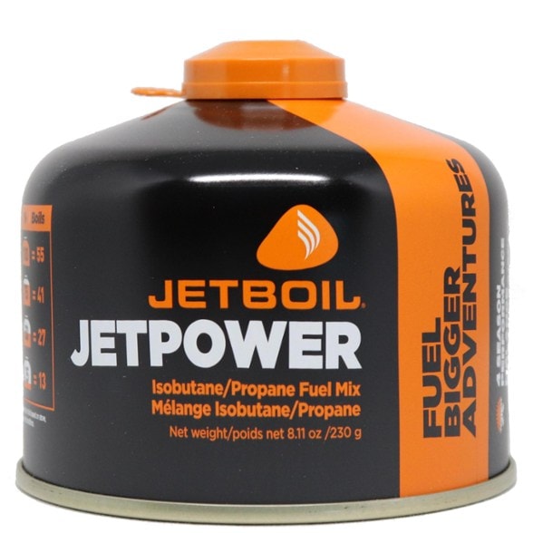 Jetboil fuel canister in a snowy camping setting, ready for use.