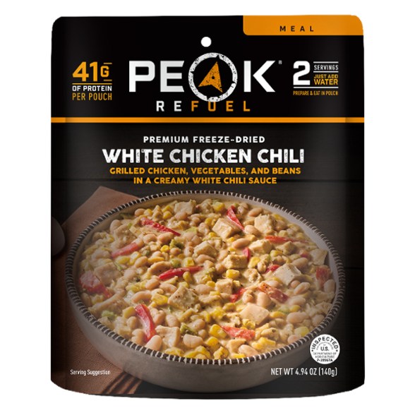 A close-up of creamy chicken chili served in a bowl, showcasing tender chicken and beans.