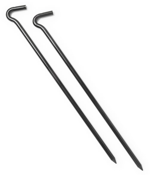Side view of steel tent pegs securing a large canvas tent in firm soil