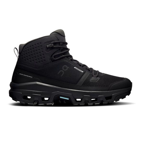 Side view of Cloudrock Waterproof Hiking Boots for Men on rocky terrain.