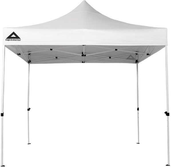 Side view of the versatile pop up shelter set up at a beach, showcasing its adjustable height and UV protection.