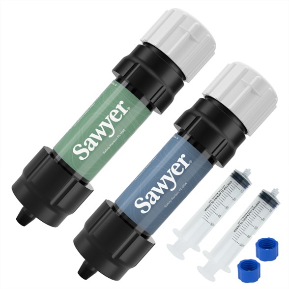 Sawyer mini water filter attached to plastic bottle in mountain trail setup