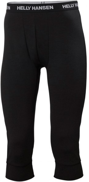 Men wearing LIFA merino midweight base layer pants in snowy landscape, showcasing comfort and warmth for skiing.