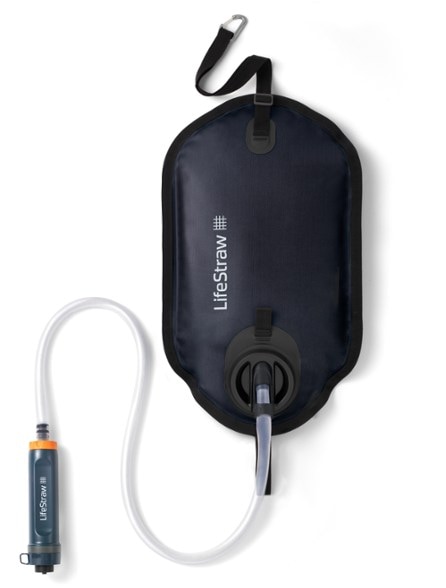 TrailGuard GravityFlow 8L system hung from a tree branch during a group campsite purification