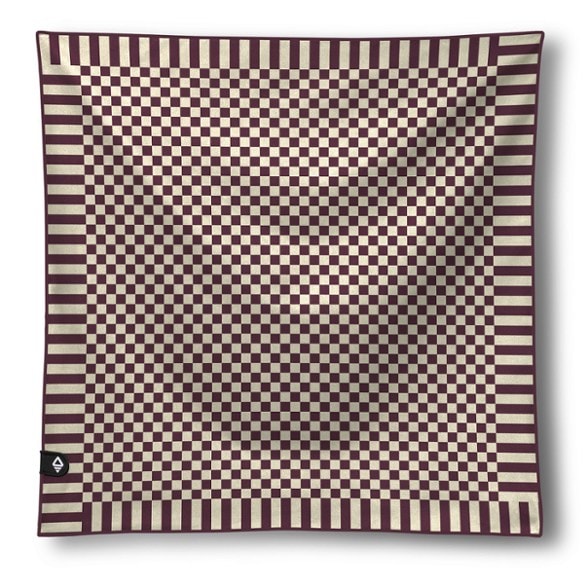 Nomadix quick dry camping bandana towel in use during a hike, showing its vibrant colors and lightweight design.