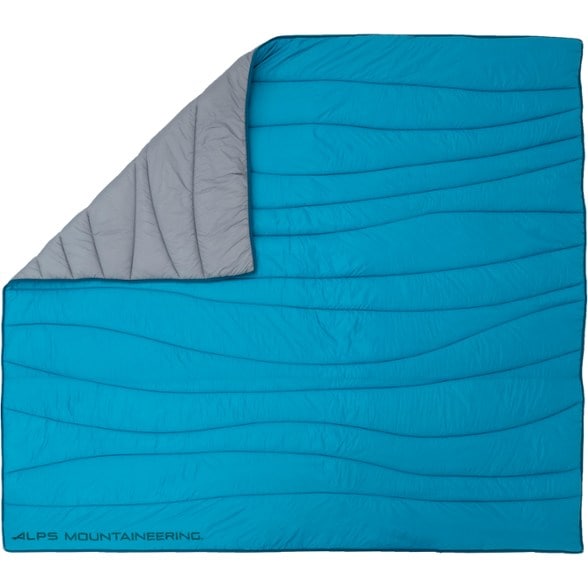 Alpine Duo insulated blanket spread out in a campsite setting