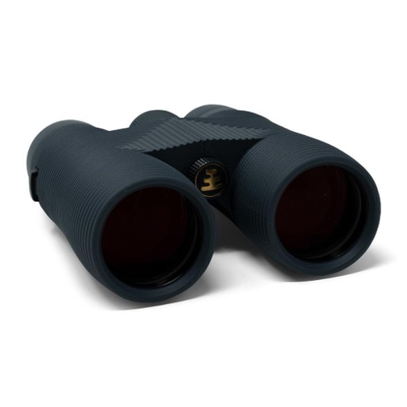 Nocs Provisions 10x42 waterproof binoculars on a nature trail, showcasing their ergonomic design.