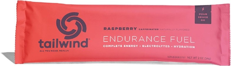 Close-up of Tailwind Caffeinated Endurance Fuel Drink Mix packet next to a water bottle.