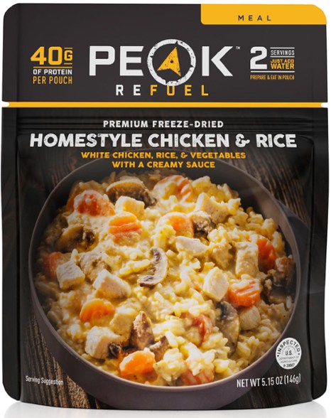 Peak Refuel Homestyle Chicken & Rice meal in a bowl outdoors, perfect for camping.