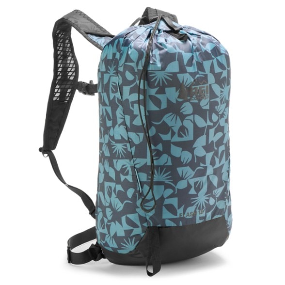 Eco-Friendly Flash 18 Lightweight Hiking Backpack with hydration reservoir on a mountain trail.