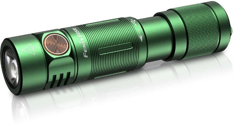 Fenix E05R keychain flashlight in a hand, demonstrating its compact size and high lumen output.