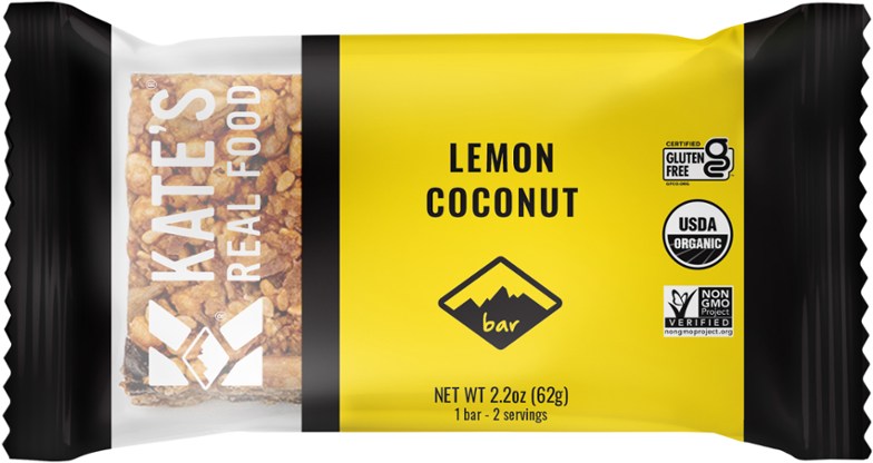 Zesty Organic Lemon Coconut Energy Bar in vibrant outdoor setting, showcasing its bright yellow and white colors.