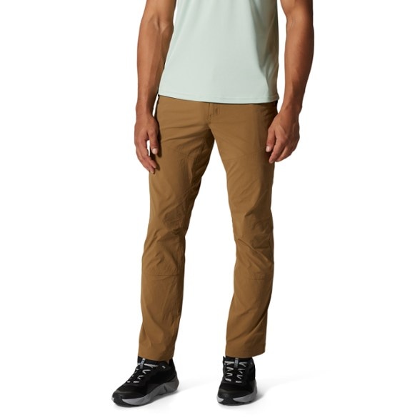 Men's Basin Trek Pants showcased on a rocky trail, emphasizing their durability and water resistance.