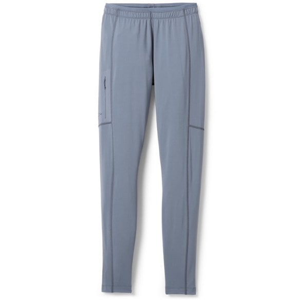 Men's thermal performance leggings displayed on a rocky outdoor surface, showcasing the durable fabric.