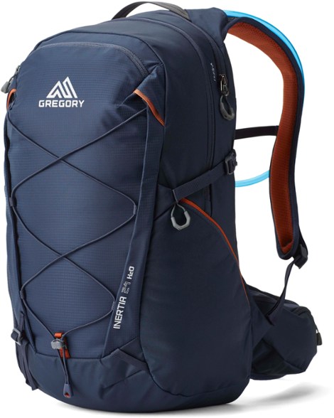Gregory Inertia 24 hydration pack displayed on a hiking trail, showcasing its ergonomic design.
