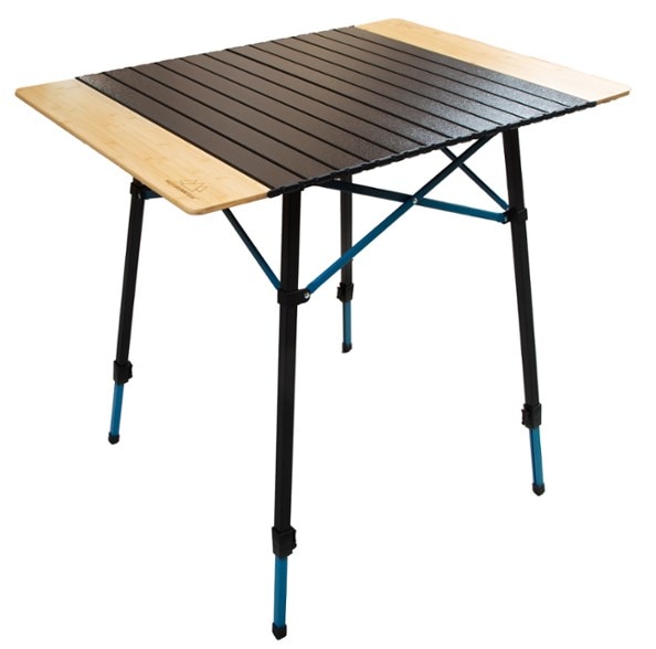 Top-down view of the folding bamboo camping table set up at a wooded campsite