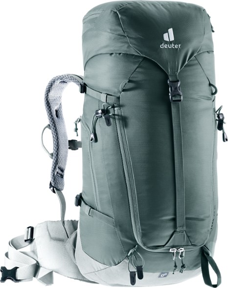 Deuter Women's Trail 28 SL hiking backpack in blue, worn by a hiker in a forest setting, demonstrating its stability and comfort.