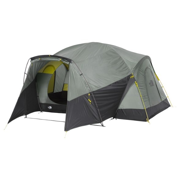 Front view of NorthPeak Shelter 8 person tent fully set up in a wooded campsite, showing large vestibule and mesh door.