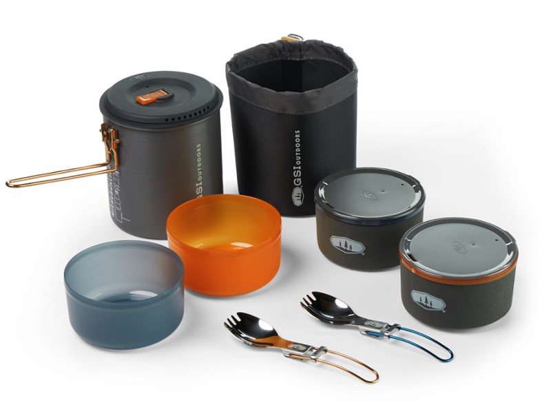Lightweight camping cookset with insulated mugs displayed outdoors