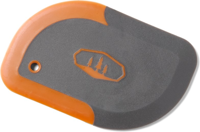 Close-up of the dual-sided pot scraper with rubber and plastic ends, perfect for cleaning pots.