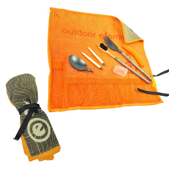 TravelMate All-in-One Utensil Set displayed in a camping setting with utensils laid out.
