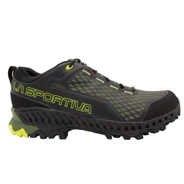 Side view of men's waterproof hiking shoes on rocky trail terrain