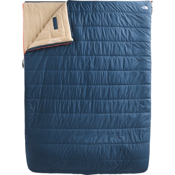 Wawona Bed double sleeping bag laid out in a campsite setting under the stars, emphasizing its spacious design.