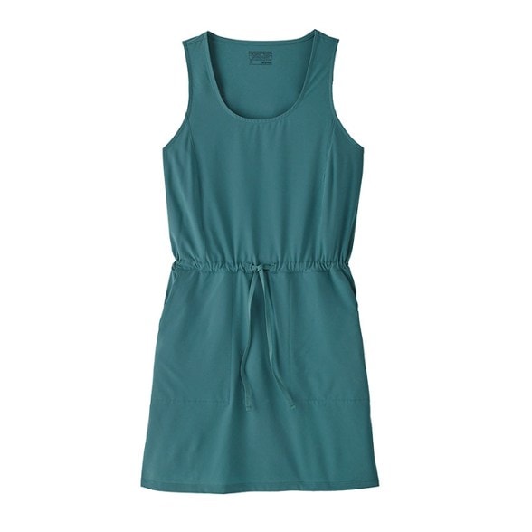 EcoVenture women's hiking dress in a lush green forest, showing its stretch fabric.