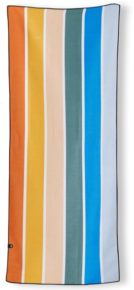 Eco-friendly quick-dry yoga towel laid out on a beach towel, showcasing its lightweight and absorbent fabric.