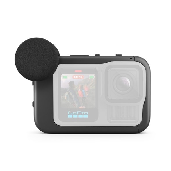 Close-up of GoPro media mod with cold-shoe mounts holding external microphone and light for vlogging gear