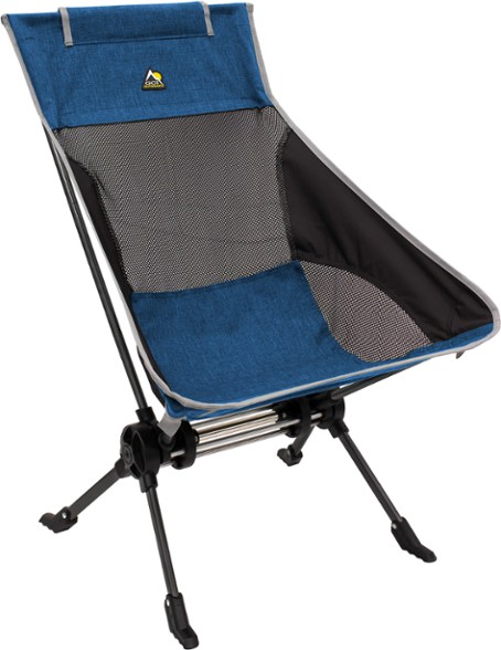 ComPack portable rocking chair set up at a campsite, showcasing its back support and padded features.