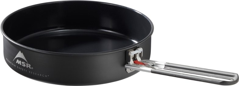 Angled top-down view of nonstick frying pan on a trail stove