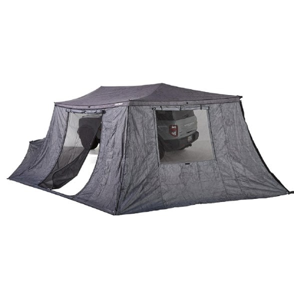 Side angle showing Yakima OverNOut wall panels attached to a camping awning in forest setting