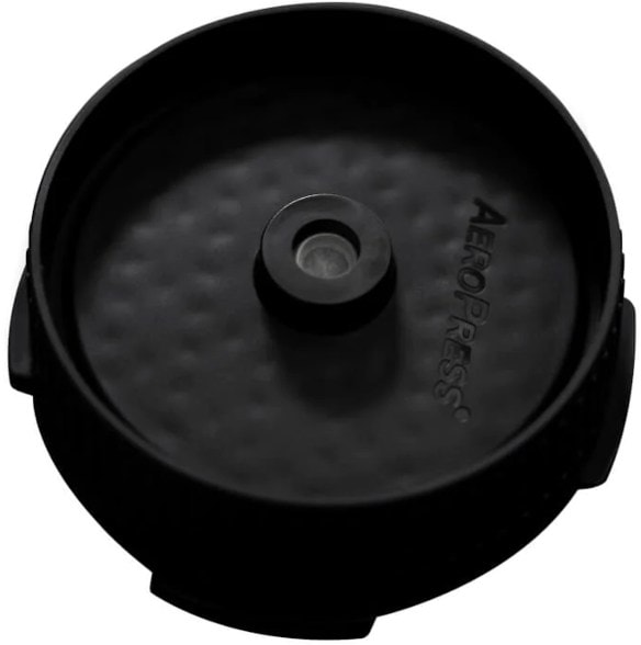 AeroPress Flow Control Filter Cap attached to AeroPress with coffee grounds ready for brewing.