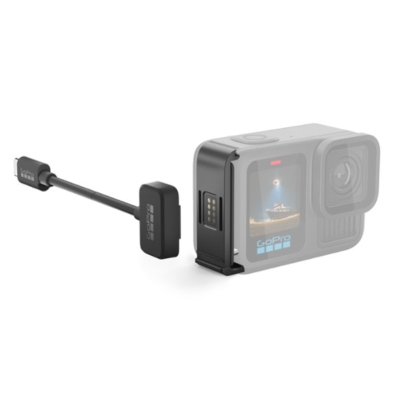 Close-up view of Contacto magnetic camera charger attached to GoPro, highlighting waterproof seal