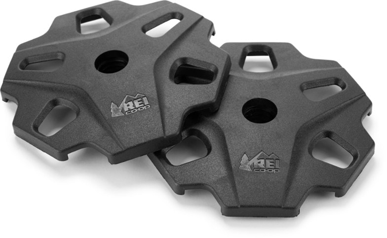 Close-up of REI Co-op snow baskets attached to trekking poles in snowy terrain.