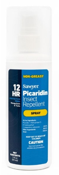 Sawyer Picaridin spray bottle on a camping table with nature background.