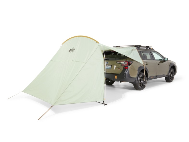 SUV tailgate canopy in use during a camping trip, providing shelter from the sun.