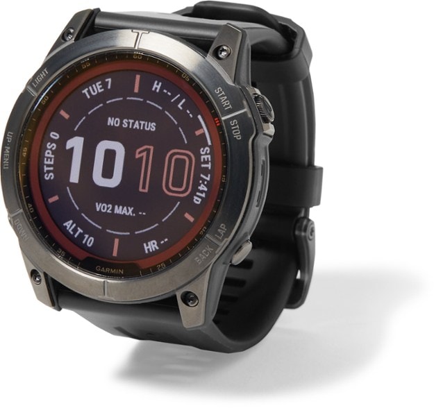 Garmin Fenix 7X Sapphire Solar GPS watch on a hiking trail, highlighting its rugged design.