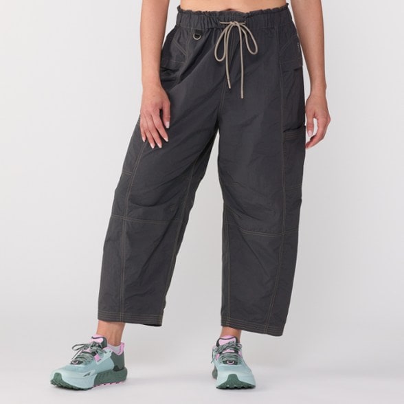TrailBlazer Women's Sun Protection Pants displayed on a rocky trail, highlighting their durable fabric and relaxed fit.