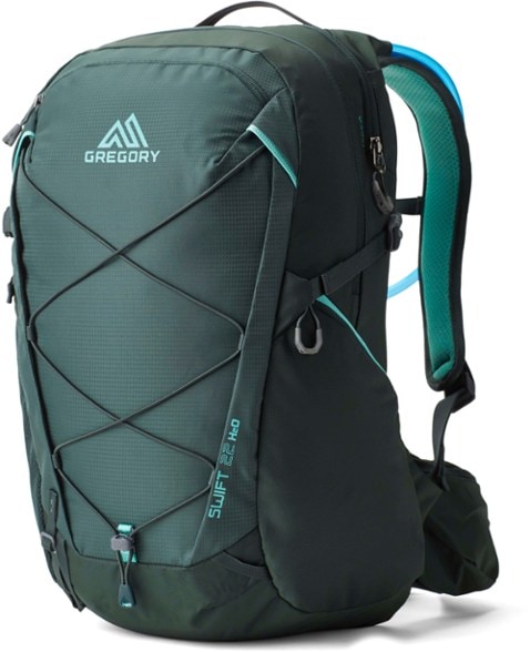 Swift 22 hydration pack worn by a woman while hiking, showcasing its comfortable fit