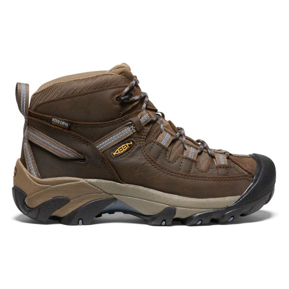 Side view of KEEN Women's Targhee II Mid waterproof hiking boots on rocky terrain.
