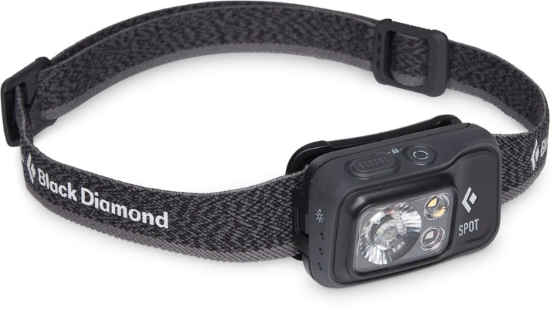 Black Diamond Spot 400 rechargeable headlamp showing bright light on a trail.