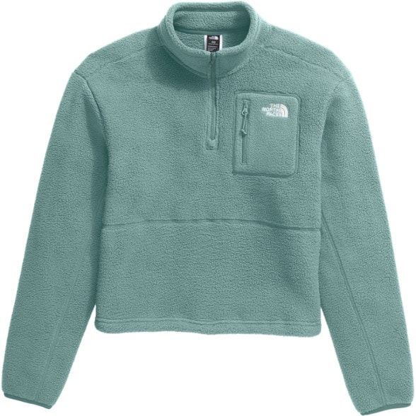 Eco-friendly women's quarter-zip pullover in a cozy outdoor setting, showcasing its soft recycled fleece.