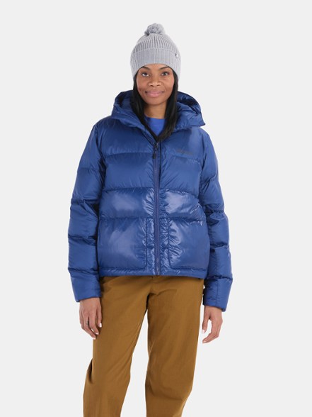 Front view of women's down jacket in forest green with adjustable hood and zippered pockets