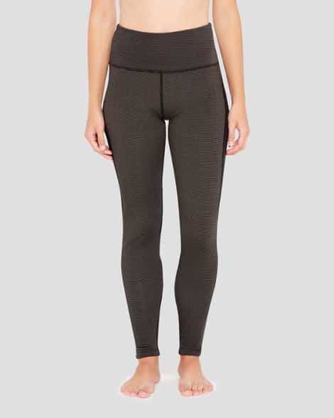 Front view of women's lightweight thermal pants for cold weather running with sleek yoga waistband and hidden pocket