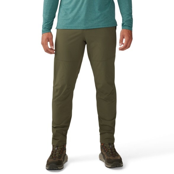 Chockstone hiking pants in action on a rocky trail, showcasing their stretchable fabric.